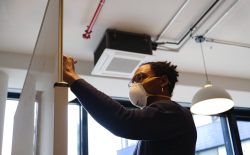 man writing on white board